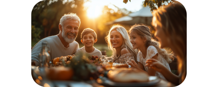 Photo of family at a dinner table outside