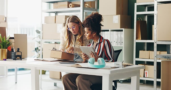 Two female employees working with a tablet