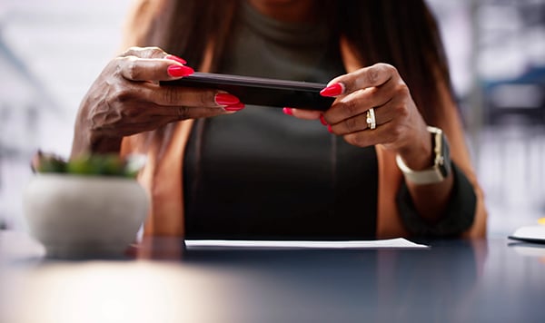 photo of a woman taking a picture of a check to deposit