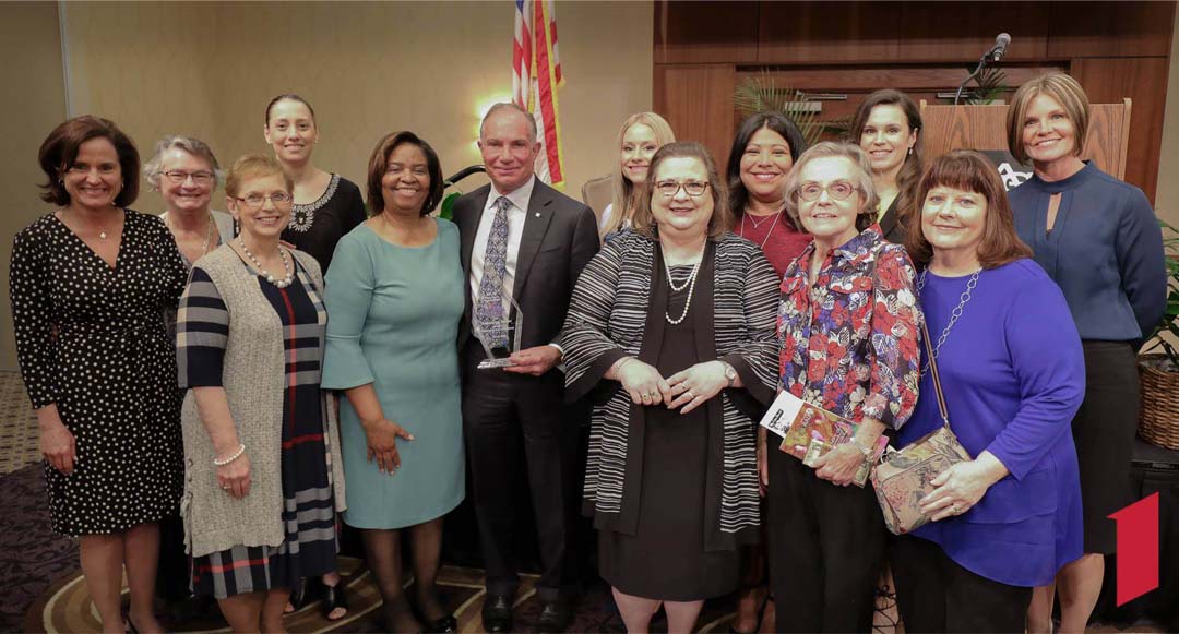 Scott Deuser with group of female employees